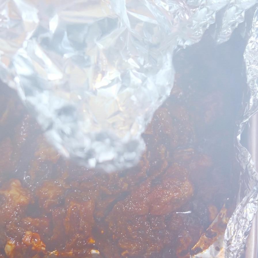 開けたばかりのホイルから立ち上がる湯気と、濃い色に焼き上がったジューシーな豚肉。