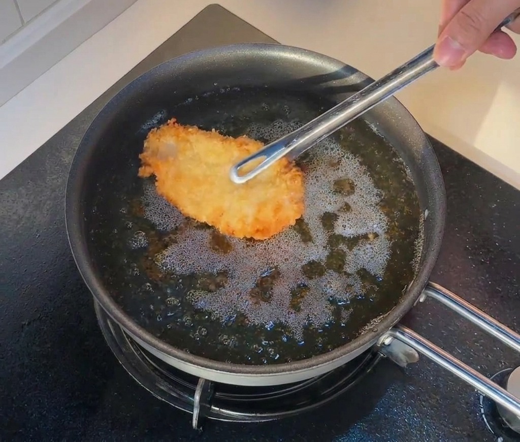 一度揚げた鶏肉を、さらに高温の油に戻して2度揚げしている様子。