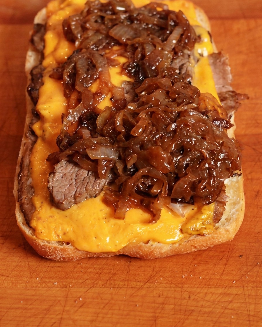 チーズの上に炒めた玉ねぎを乗せている様子。