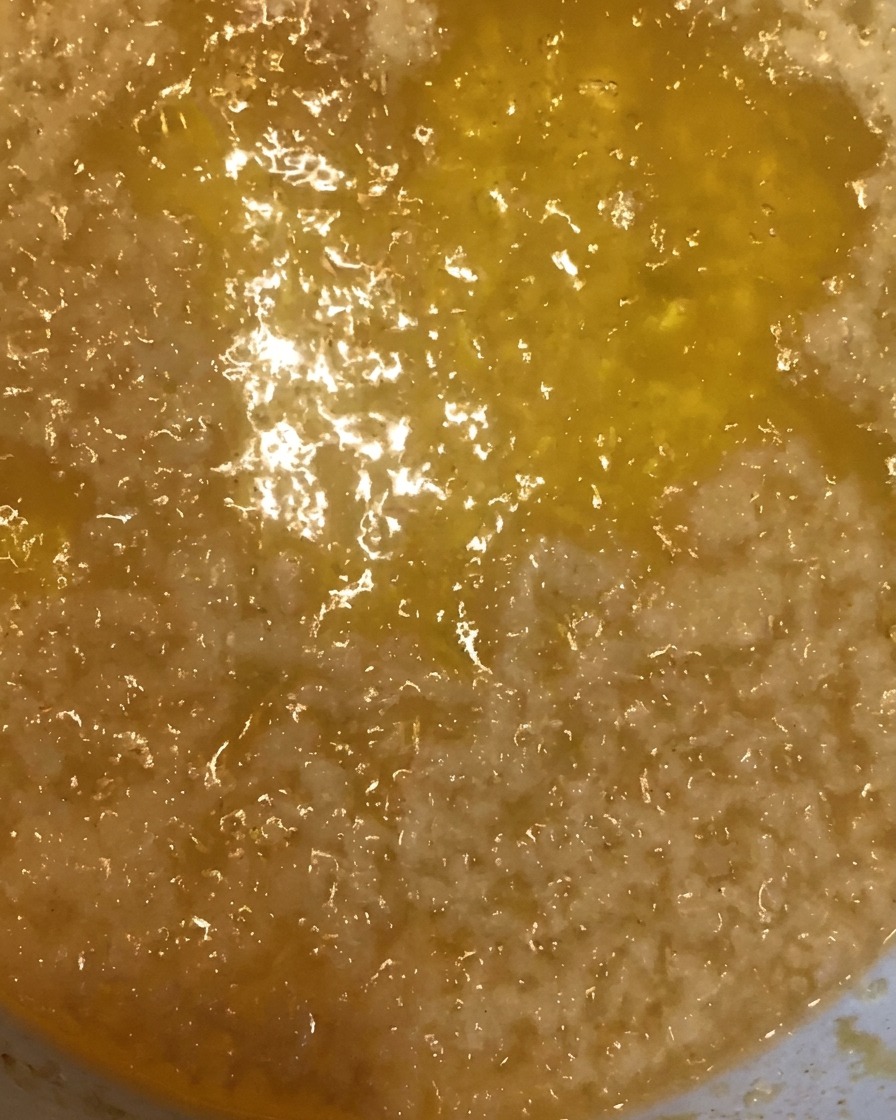 金属製の網で揚げたての天かすをすくっている様子。