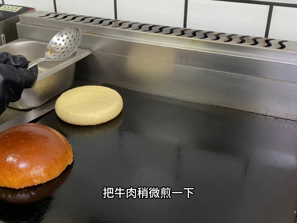 熱い鉄板の上に置かれた生のビーフパティ。