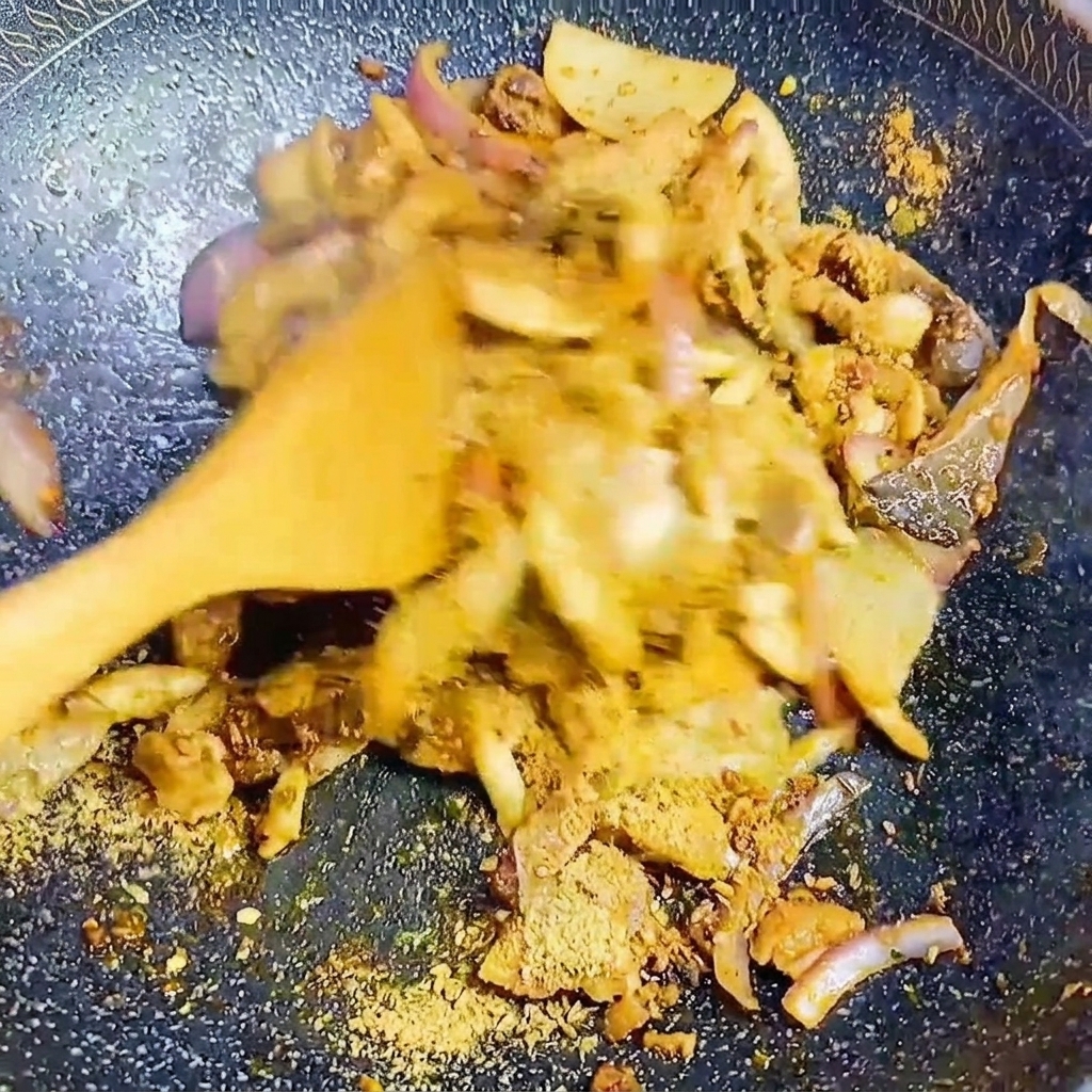 フライパンの中で、韓国風BBQシーズニングと一緒にキノコと玉ねぎを炒め合わせている様子。