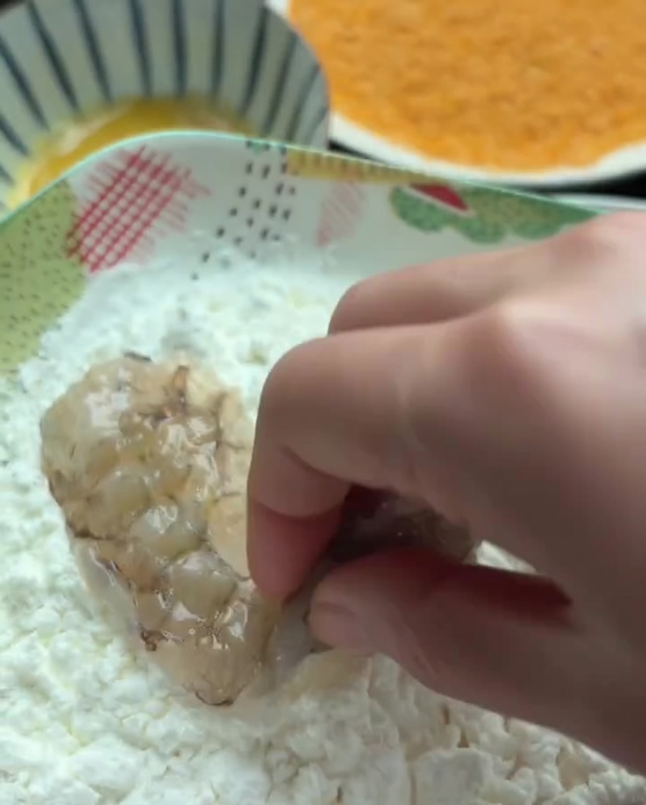 片栗粉の入ったボウルに海老を入れている様子。