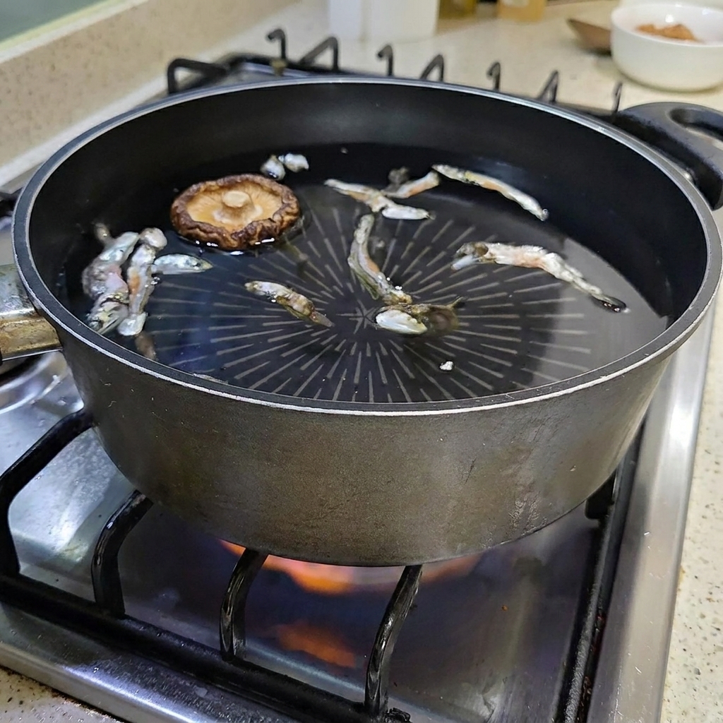 煮干しが入った鍋の中で水に浮いている干し椎茸。