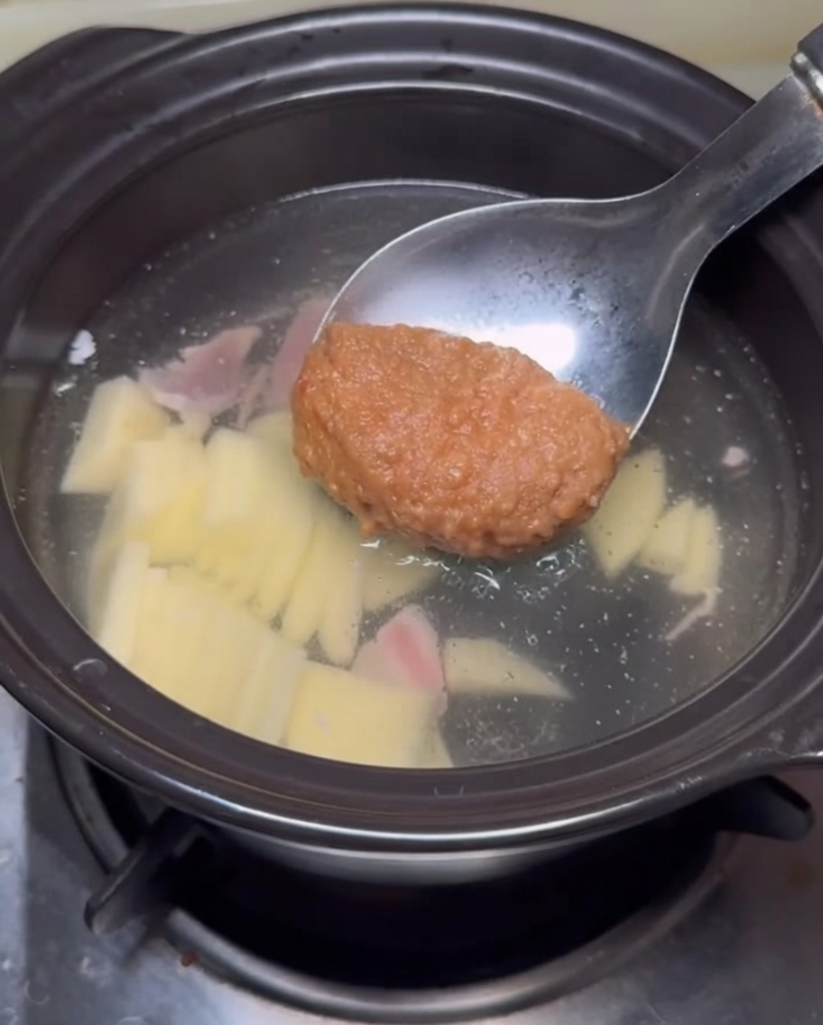 スープに味噌を溶かし入れる様子。