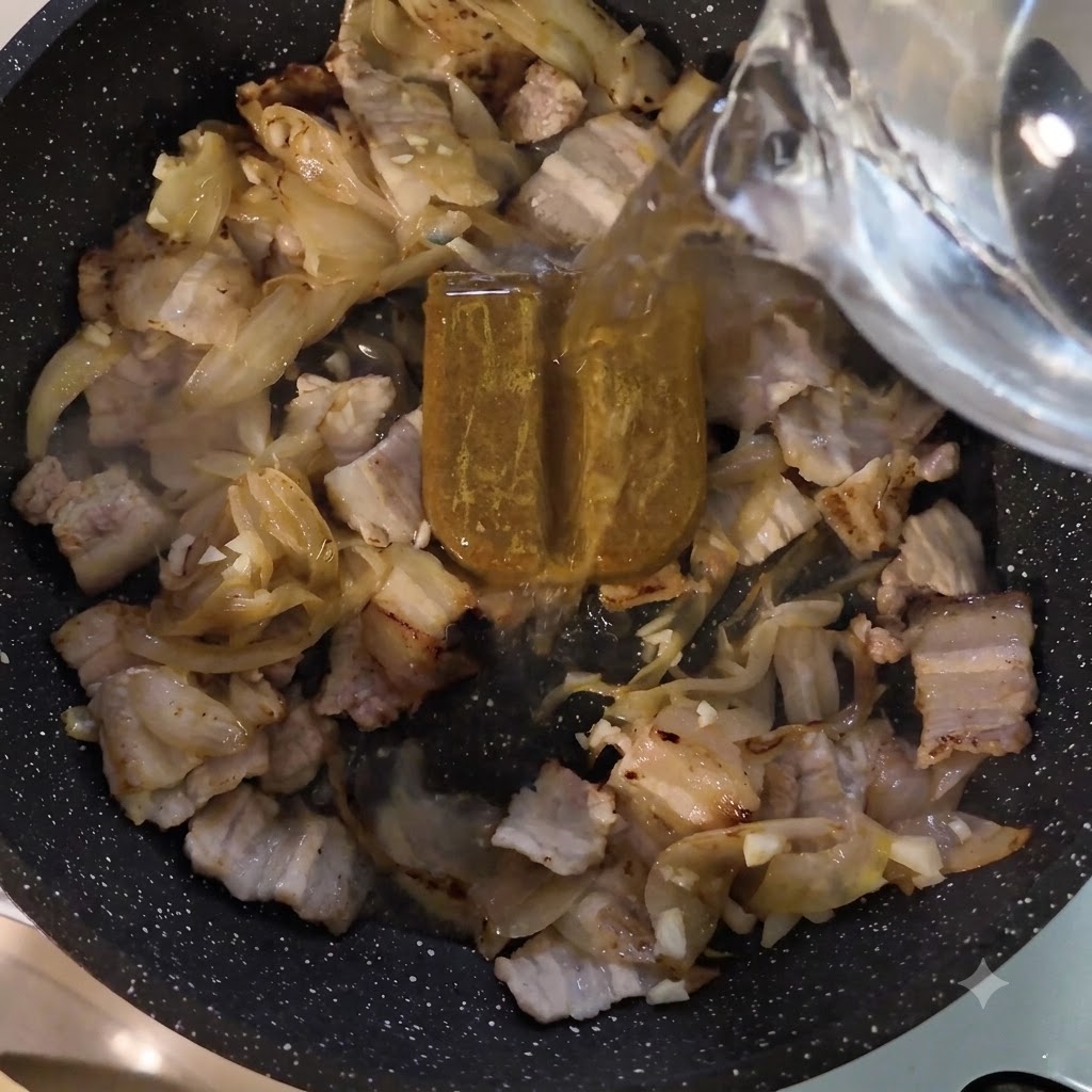 カレールーと具材が入ったフライパンに水を注いでいる様子